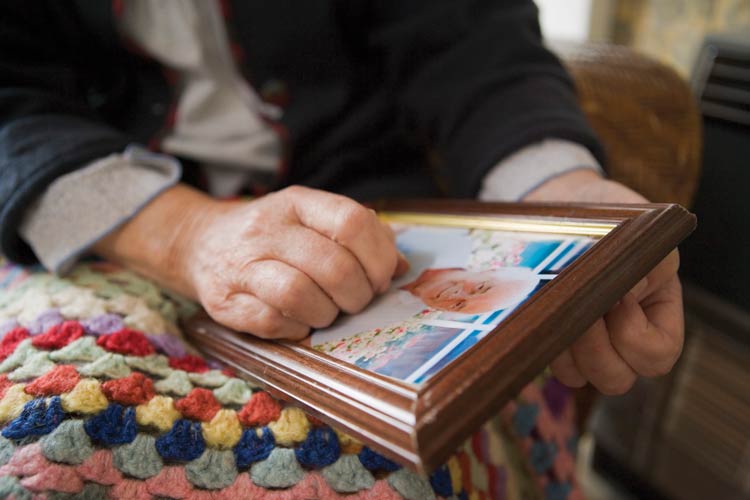 a photo of a woman's hands holding a picture of a man