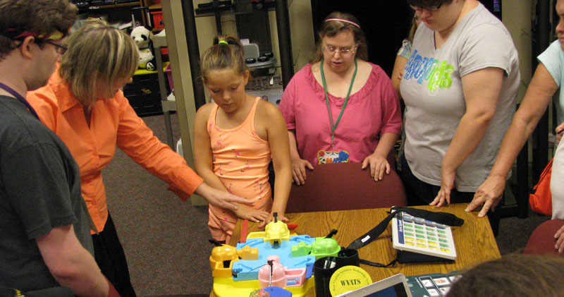 a photo taken of several peopel using various AT at a workshop