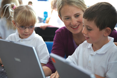 a photo of a children working on a computer