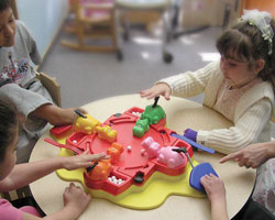 children playing hungry hippos
