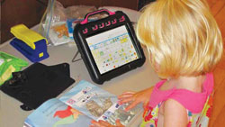 a photo of a girl using at with an ipad