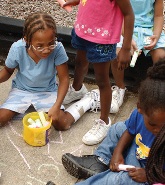 children palying with chalk on sidewalk
