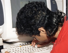 boy typing on a computer keyboard