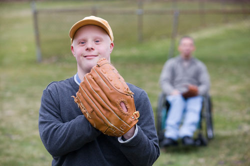a photo of a young man with an intellectual disability playing baseball