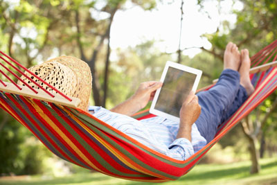 a photo of a woman in a hammock reading the WVATS newsletter