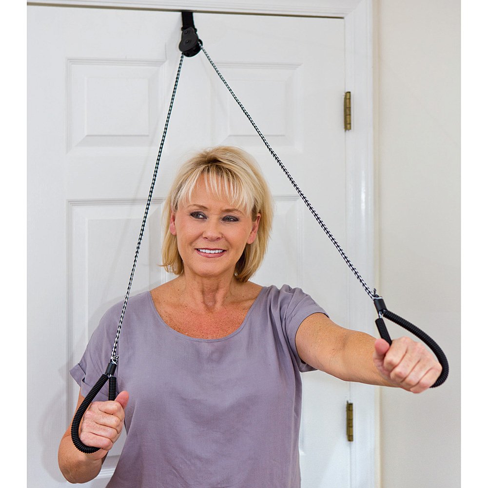 a photo of a woman using the pulley over a door