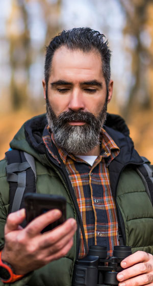 a photo of a hiker staring at his phone